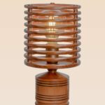 Contemporary wooden table lamp with cylindrical cage design and exposed LED bulb, crafted for ambient lighting in modern living spaces.