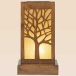 Wooden table lamp with intricate tree silhouette and warm light – handcrafted by DARKAR, available at Checkmark Trading Dubai-front view
