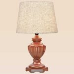 Classic handcrafted wooden table lamp with carved vase-style base and beige fabric shade – DARKAR design, available at Checkmark Trading Dubai