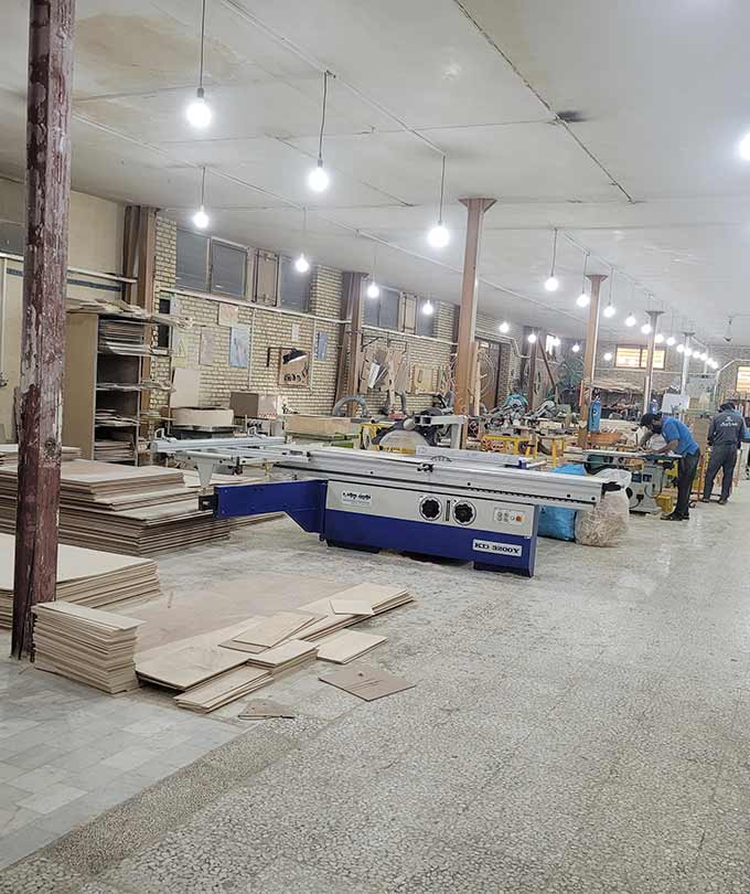 DARKAR woodworking workshop with modern machinery and skilled craftsmen producing handcrafted wooden lighting components