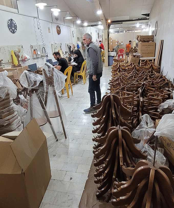 DARKAR factory assembly line with skilled workers and wooden chandelier parts organized for final production