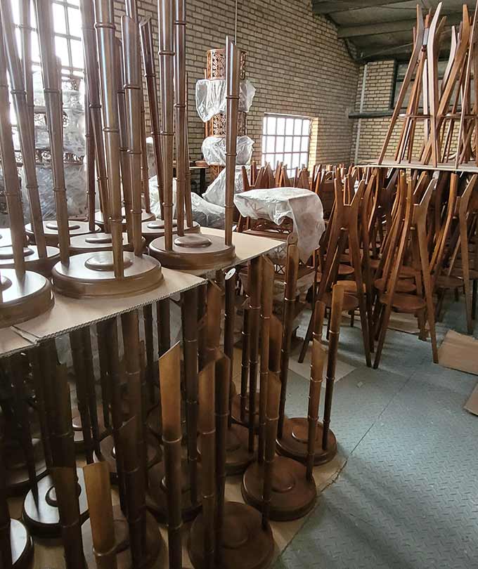 Unassembled wooden furniture parts stacked in DARKAR warehouse, ready for production and assembly of high-quality lighting and decor products-different-view