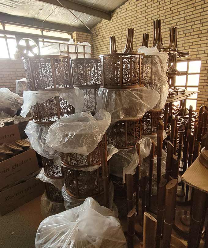 Unassembled wooden furniture parts stacked in DARKAR warehouse, ready for production and assembly of high-quality lighting and decor products-another-angle