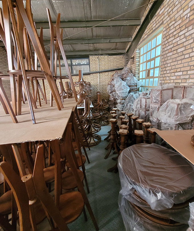 Unassembled wooden furniture parts stacked in DARKAR warehouse, ready for production and assembly of high-quality lighting and decor products