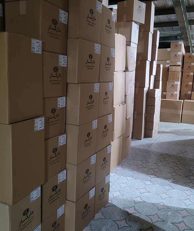 Stacked shipping boxes at DARKAR lighting warehouse, ready for export and delivery of premium wooden chandeliers