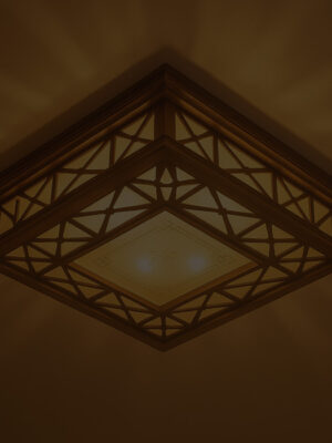 Square wooden ceiling light with intricate geometric lattice design and soft warm glow, perfect for traditional and oriental interiors
