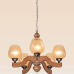 Traditional wooden chandelier with six engraved frosted glass shades, suspended by a rustic chain, ideal for classic dining rooms or cozy interiors-from-below