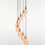 Ten-light spiral pendant lamp with frosted globe glass and carved wooden tops – Checkmark Model 38-12 – perfect for staircases, atriums, and modern rustic interiors