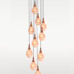 Checkmark Pendant Light 38-13 – Ten globe-shaped hanging lights with star-etched frosted glass and wooden tops, suspended in a cascading cluster from a circular wooden canopy – perfect for staircases, foyers, and rustic luxury interiors