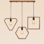Modern geometric wooden pendant light with three hanging frames – Checkmark model 44 – featuring diamond, hexagon, and square shapes with warm filament bulbs