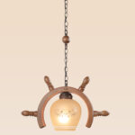 Wooden pendant light shaped like a ship wheel with patterned frosted globe – Checkmark Model 46 – ideal for rustic cafés, themed interiors, and vintage-inspired rooms