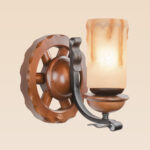 Rustic nautical wooden wheel wall sconce light with frosted drip-effect glass shade – distributed by Checkmark, crafted by DARKAR Lighting Industries.