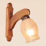 Single wooden wall sconce light with frosted floral glass shade – distributed by Checkmark, crafted by DARKAR Lighting Industries