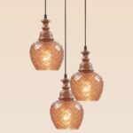 Triple pendant light with wooden crowns and amber-patterned glass globes – Checkmark Model 61-3 – rustic cascading lighting with pinecone-style glow