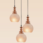Triple pendant light with wooden tops and frosted globe glass shades – Checkmark Model 60-3 – vintage-inspired cascading lighting with warm rustic charm