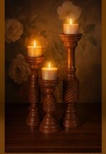 Elegant wooden candle holder set model 822 with carved spiral pillar design, handcrafted from premium wood for rustic, farmhouse, and classic interiors-lit-wooden table