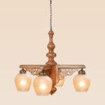Traditional chandelier model 242-4 with carved wooden body, decorative fretwork, and four frosted glass globes — Persian-inspired ceiling light by Checkmark.