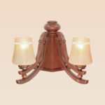 Double-arm wooden wall sconce light with curved supports and frosted etched glass shades – distributed by Checkmark, crafted by DARKAR Lighting Industries.