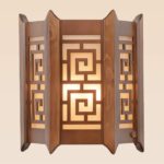 Wooden wall sconce light with geometric lattice design and frosted inner diffuser – distributed by Checkmark, crafted by DARKAR Lighting Industries.