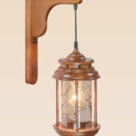 Rustic wooden wall sconce light with hanging lantern-style glass enclosure – distributed by Checkmark, crafted by DARKAR Lighting Industries.