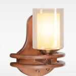 Wooden wall sconce light with layered circular base and double glass cylindrical shade – distributed by Checkmark, crafted by DARKAR Lighting Industries.