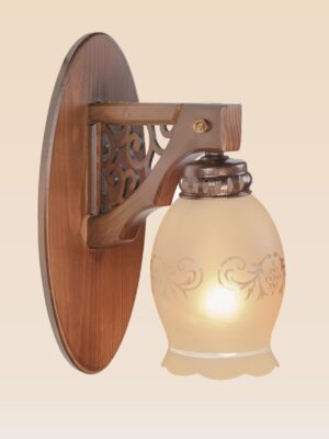 Wooden wall sconce light with ornate side panel and floral-etched frosted glass shade – distributed by Checkmark, crafted by DARKAR Lighting Industries.