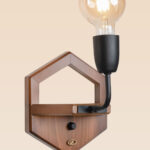Wooden wall sconce light with pentagon-shaped backplate and exposed Edison-style bulb – distributed by Checkmark, crafted by DARKAR Lighting Industries.