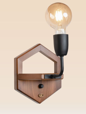 Wooden wall sconce light with pentagon-shaped backplate and exposed Edison-style bulb – distributed by Checkmark, crafted by DARKAR Lighting Industries.