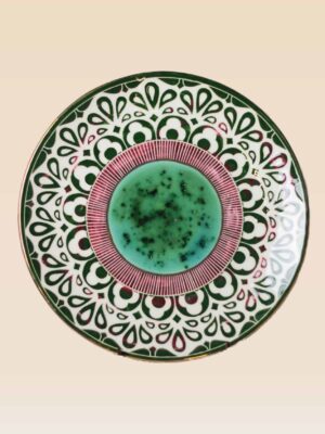 Handmade ceramic decorative plate featuring green glaze and artisan patterns