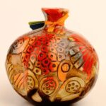 Carved ceramic pomegranate décor with relief surface detail and layered glaze