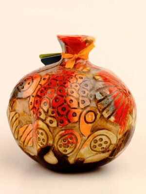 Carved ceramic pomegranate décor with relief surface detail and layered glaze