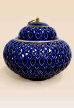 Openwork ceramic lidded jar with glossy glaze and sculptural form