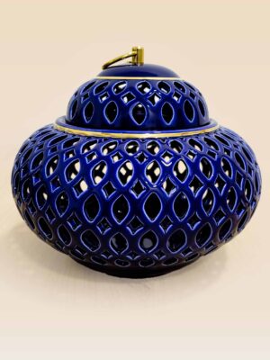 Openwork ceramic lidded jar with glossy glaze and sculptural form