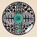 Handcrafted ceramic decorative dish with traditional black and green motifs