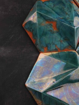 handcrafted ceramic decorative tile with faceted green glaze and amber accents