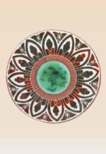 Close-up detail of handcrafted ceramic decorative dish showing hand-painted texture