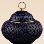 Openwork ceramic lidded jar with glossy glaze and sculptural form
