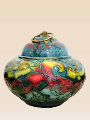 Patina glaze ceramic lidded jar with layered color tones and sculptural form