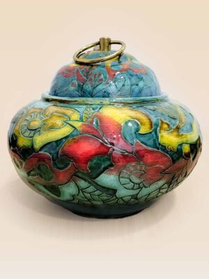 Patina glaze ceramic lidded jar with layered color tones and sculptural form