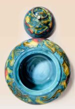 Patina glaze ceramic lidded jar with layered color tones and sculptural form open lid