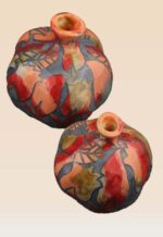 Close-up of pomegranate ceramic art showing hand-painted glazing