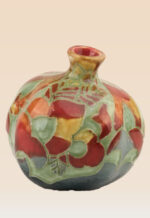 Glazed pomegranate ceramic art with rich color and organic form