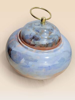 Refined glaze ceramic lidded jar with smooth surface and sculptural form top side view