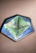 Close-up of prism hex tile showing angular planes and reflective finish