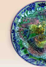 decorative ceramic dish blue green pattern design patina style close up