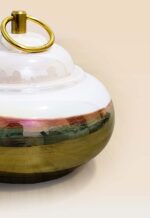 Refined glaze ceramic lidded jar with smooth surface and sculptural form close up small
