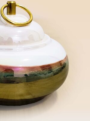Refined glaze ceramic lidded jar with smooth surface and sculptural form close up small