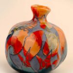 Incised ceramic pomegranate with handmade carved pattern and layered glaze