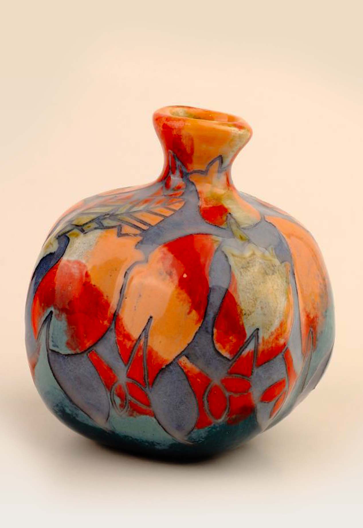 Incised ceramic pomegranate with handmade carved pattern and layered glaze Incised ceramic pomegranate with handmade carved pattern and layered glaze