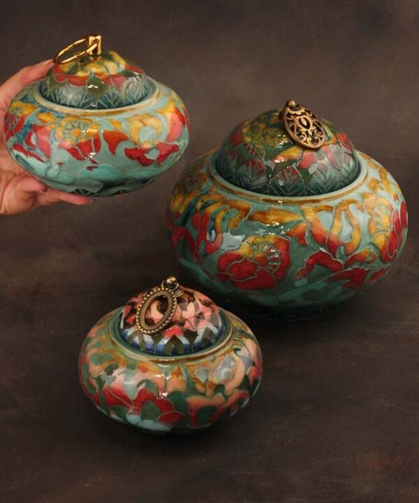 Ceramic lidded jars styled on a refined console table with warm lighting
